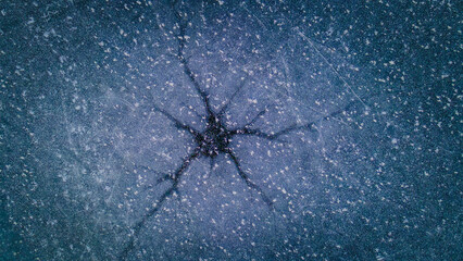 a frozen crack in the ice of a frozen pond