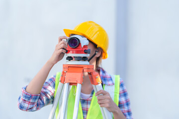 Female survey working Using Theodolite Surveying Optical Instrument for Measuring Angles in Horizontal and Vertical Planes on Construction Site.