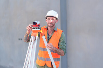 Survey engineers at construction sites use theodolite to mark coordinating concrete piles.