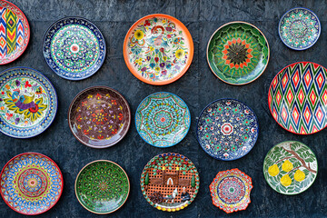 Arabic painted ceramic plates on the wall. - obrazy, fototapety, plakaty