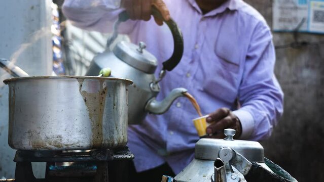 Tea being poured by a teastall vendor in Delhi Street,India