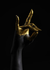 A woman's right arm, painted in gold and black on a dark background. Hand sign meaning fox in Japan. 3D illustration.