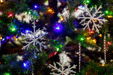 Obraz na płótnie Canvas Lights on a Christmas colorful garland create a festive background.