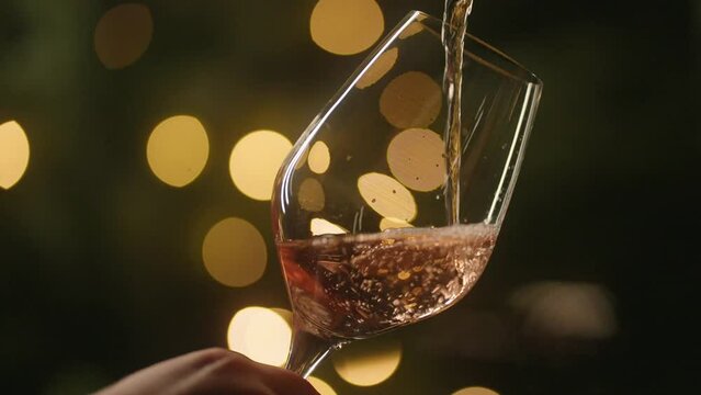 Waiter Pouring A Glass Of Cold Rose Wine, Xmas tree background
