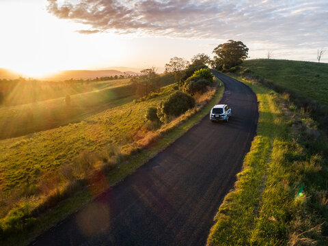 Four wheel drive car on narrow country road in Australia showing concept of travel insurance