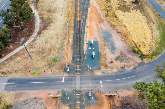 Aerial view of a road crossing a regional railway line