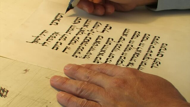 Sofer writes a Hebrew Passover Haggadah, Close up, 2022
a Jewish text that sets forth the order of the Passover Seder, Israel, 2022 
