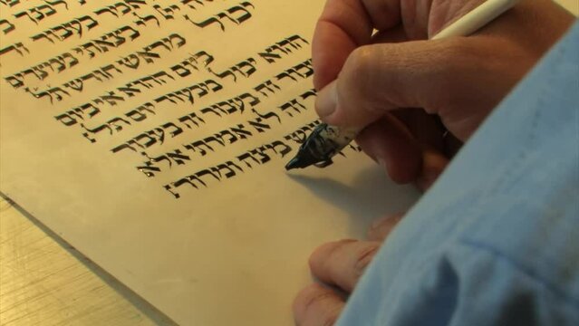 Jewish Male Sofer writes a Hebrew Passover Haggadah, close view
a Jewish text that sets forth the order of the Passover Seder, Israel, 2022 
