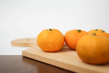 Fototapeta na wymiar Selective Focus of Orange Fruits on Woodeen Board