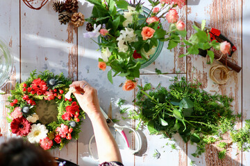 Fototapeta na wymiar 生花を使った華やかなフラワーアレンジメント　手作りの花のリース　女性フラワーデザイナー
