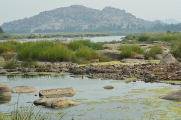 Landscape view of Vijayanagar Empire in Hampi, India. View of rocky hills along side Tungabhadra river..