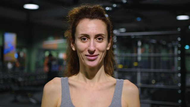 Portrait of a sporty beautiful woman looking at the camera. Woman after training in the gym. Healthy lifestyle