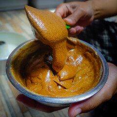 hand holding a bowl of chocolate 