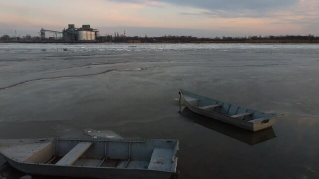 Two boats on the river. Winter, ice