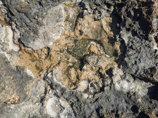 Coast of the Mediterranean Sea, long frozen lava. Background. It looks like an alien landscape.