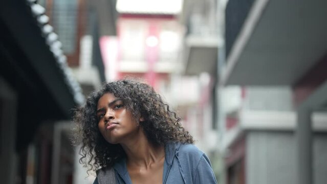 african business woman having lifr style at outdoor pedestrian space. woman in relaxing holding laptop. girl walking in relaxing and happy. she call and hand up to someone or friend.