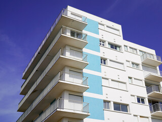 blue facade white apartment real estate building exterior architecture in blue summer sky