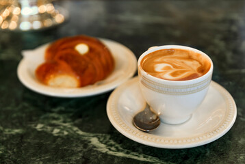 Cup of cappuccino and a cornetto at a cafe in Centro Storico, Florence, Italy