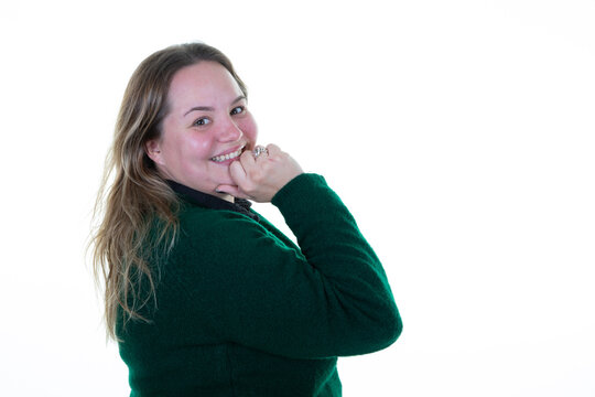 plus size pretty happy woman smiling with hand under chin attractive overweight girl posing on white background in green sweater