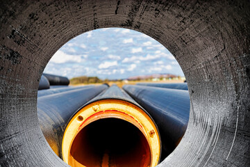 Insulated pipe. Large metal pipes with a plastic sheath at a construction site. Modern pipeline for...