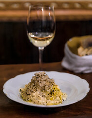 Fresh pasta with truffle in pecorino cheese wheel in restaurant, Florence, Italy