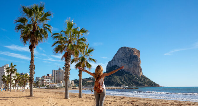 Woman looking at Calpe rock and mediterranean sea in Spain