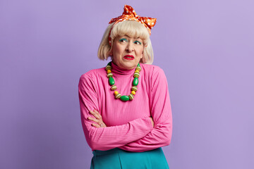 Dissatisfied Grandmother Posing Studio. Senior Woman Expressing Disbelief Irritation, Feeling Bored, Disappointed In Result Bad News Isolated On Violet Studio Wall Background 