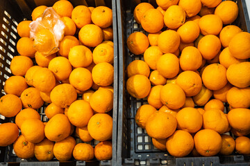 oranges in a basket close-up are sold in a shopping center in the department of vegetables and fruits
