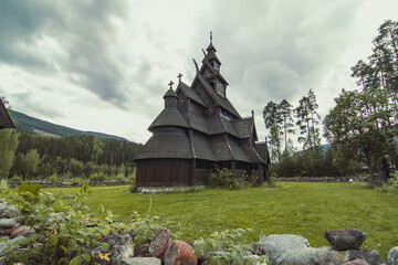 Wooden church at highland landscape photo. Beautiful nature scenery photography with highland on background. Idyllic scene. High quality picture for wallpaper, travel blog, magazine, article