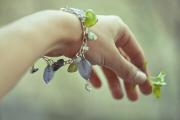 Close up stylish bracelet on female wrist concept photo. Craft jewelry. First view hand photography...