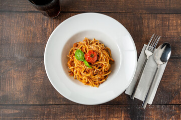 Spaghetti with bolognese sauce on a white porcelain plate