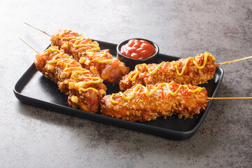 Korean style french fries corn dog Gamja hotdog closeup on the plate on the table. Horizontal