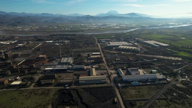 Industrial area with metallurgic factory chimneys and warehouses in Elbasan, Albania