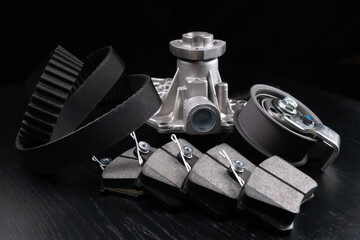 Close up auto parts spare parts car on grey background. Large number rotate on turntable around its axis. Auto parts store. Suspension and engine parts.