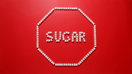 octagonal frame in the form of a stop sign made of sugar cubes with red background and word sugar inside. stop eating refined sugar concept