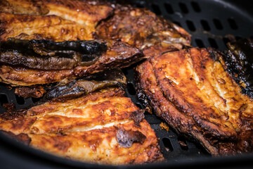 Milkfish fried in the air fryer. Sizzling hot. Bangus is a favorite in the Philippines. Filipino cuisine.
