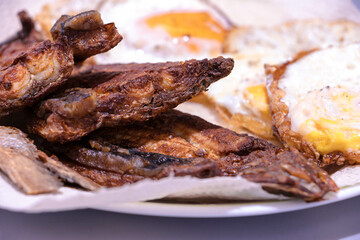 Fried bangus or milkfish with easy made eggs, served while hot. Deep fried fish. Filipino cuisine.