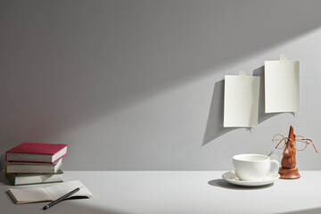 light gray desk at morning with window light. copy space
