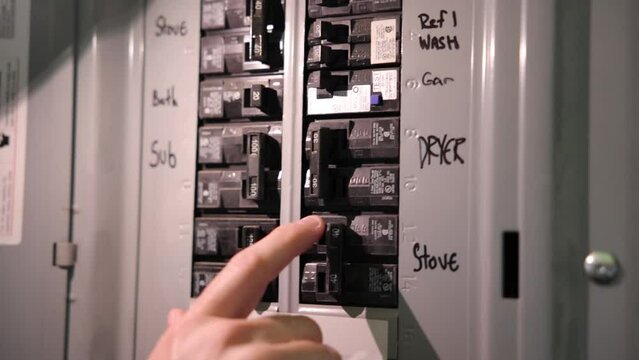 Man flips power switches during a power outage