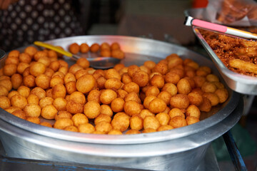 Sweet fried potato balls. Sweets in the Asian street food market