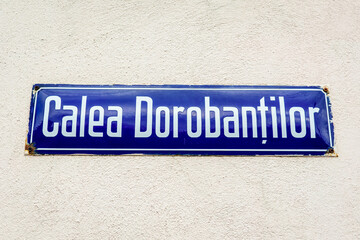 Obraz premium Beautiful vintage street sign showing Calea Dorobantilor (Dorobantilor Avenue) displayed on an street in the old city center of Bucharest, Romania, in a sunny day with clear blue sky