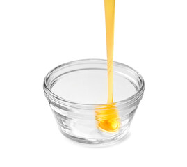 bowl of pouring honey isolated on white background