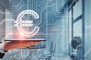 Close up of hand holding cellphone with glowing euro circuit sign on blurry office interior background. Digital money transaction concept. Double exposure.