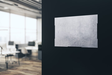 Modern blurry office interior with empty banner on dark wall. Mock up, 3D Rendering.