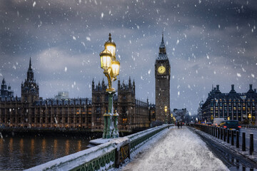 Winter view of the Westminster Bridge and Big Ben clocktower in London during a winter day with ice...