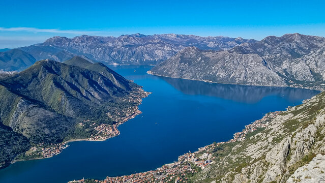 Panoramic view from Pestingrad (Derinski Vrh) of Kotor bay in sunny summer, Adriatic Mediterranean Sea, Montenegro, Balkan Peninsula, Europe. Fjord winding along coastal towns. Lovcen, Orjen mountains