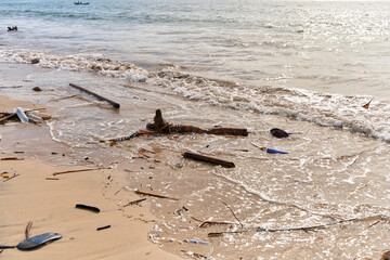 Mountains of waste and garbage on the sandy beach after the tide. Humanity is polluting the ocean