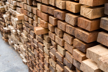 Piles of  Mixed wood  Pine wood  in the sawmill, planking. Warehouse for sawing boards on a sawmill outdoors. Wood timber stack of wooden blanks construction material Industry.
