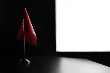 Small national flag of the Switzerland on a black background