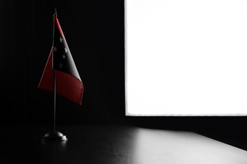 Small national flag of the Papua New Guinea on a black background